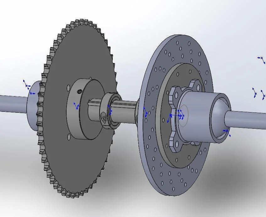 Assembly of a shaft with a sprocket, collar, brake rotor, and hub